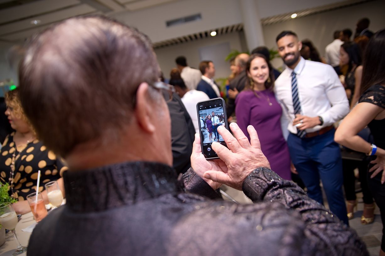 Guests photographing graduates at the reception