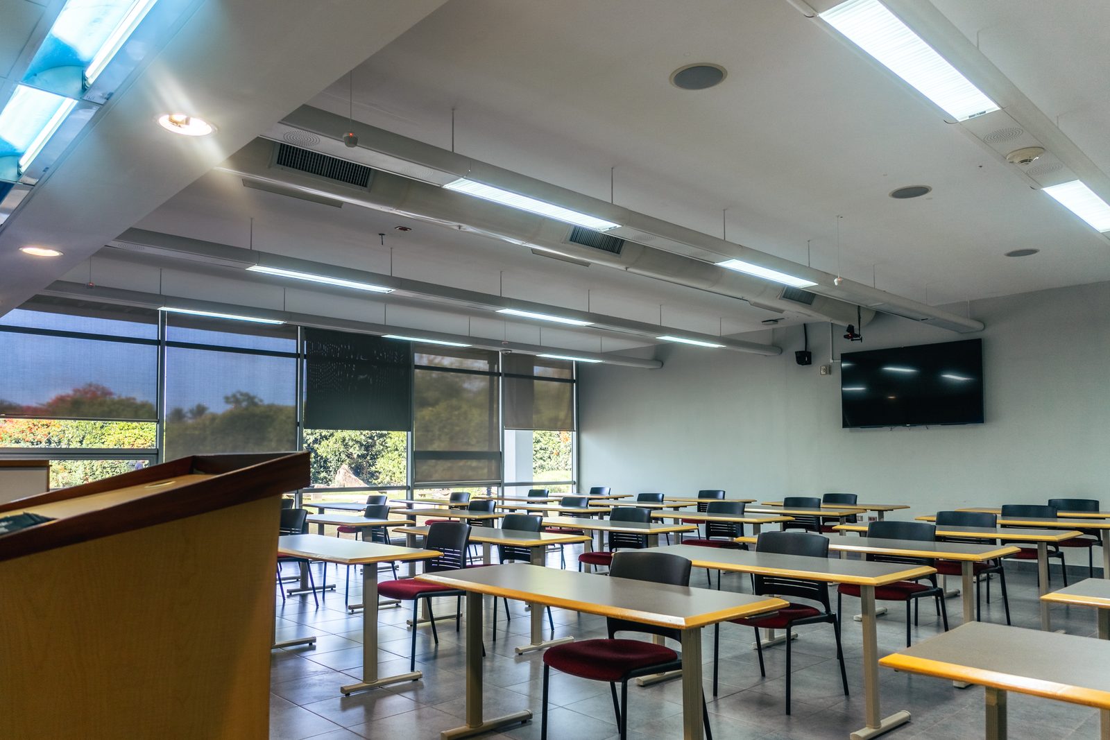 A campus classroom with lectern and screen