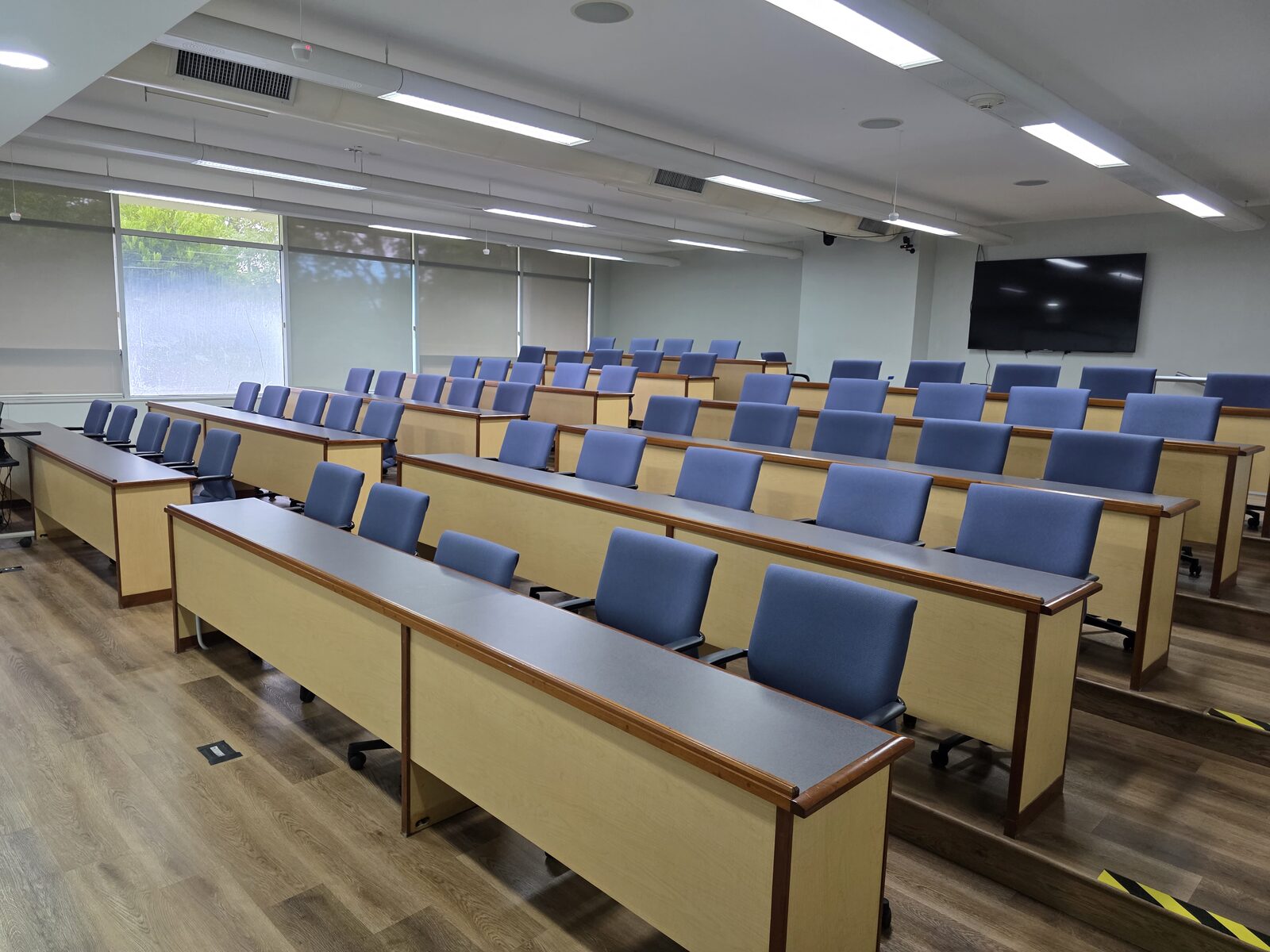 Sidney Knox Room - tiered theatre-style seating with blue upholstered desks