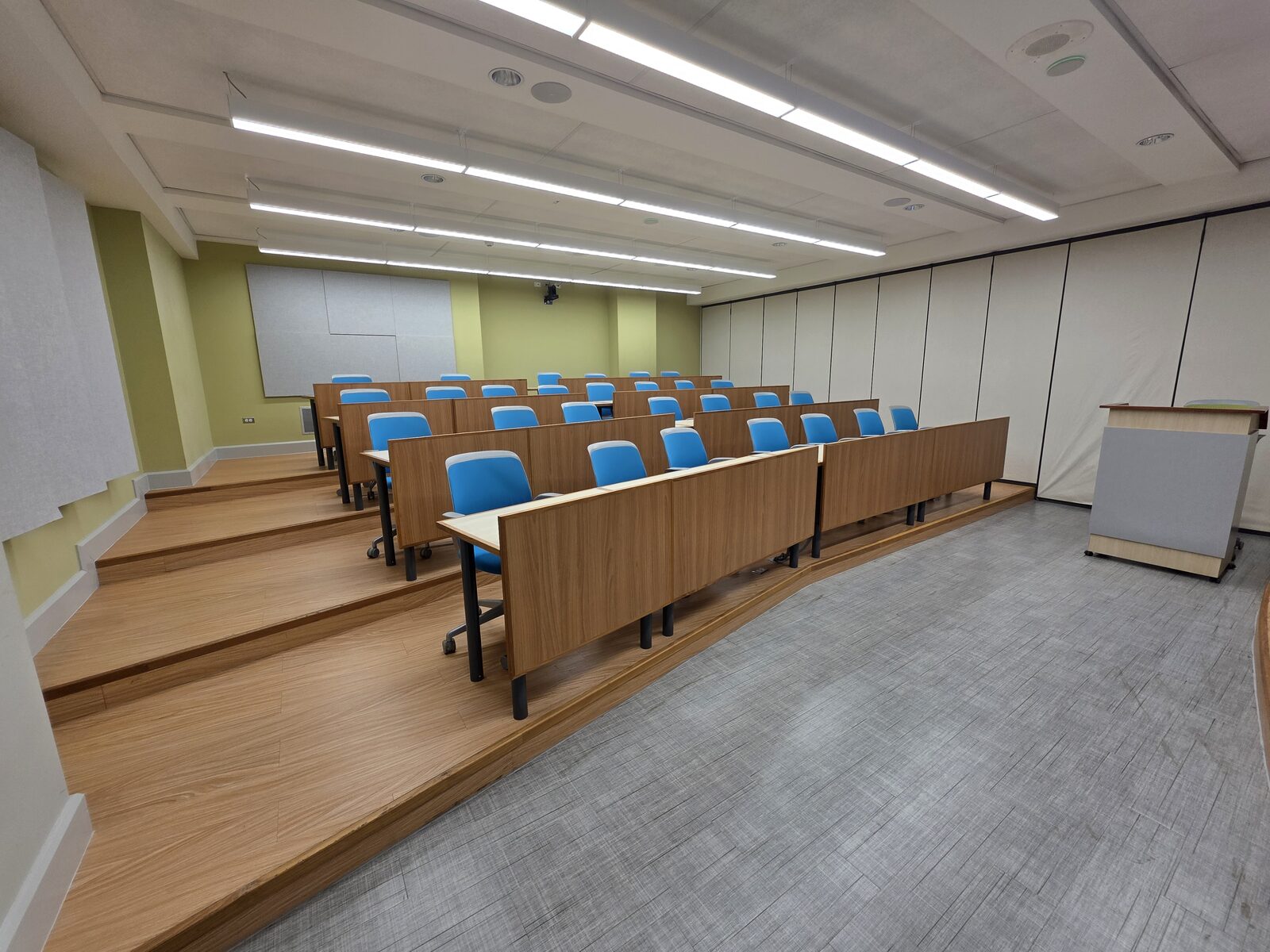 Lecture Room 1 - tiered seating and curved desks seen from the front