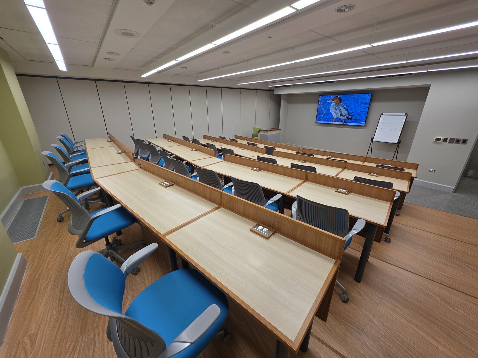 Lecture Room 1 - curved desk rows with the screen at the front